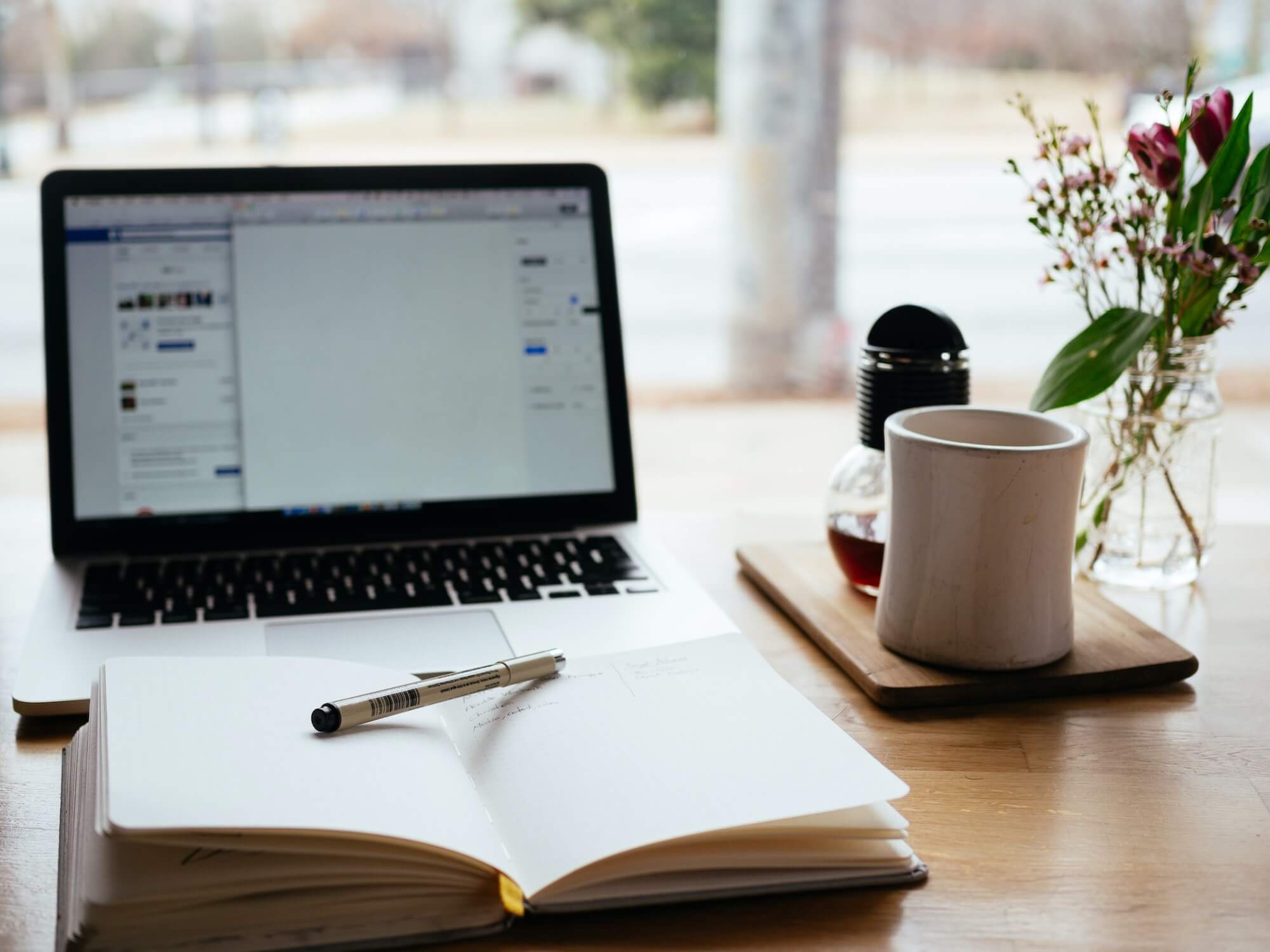 Coffee and notebook on a desk