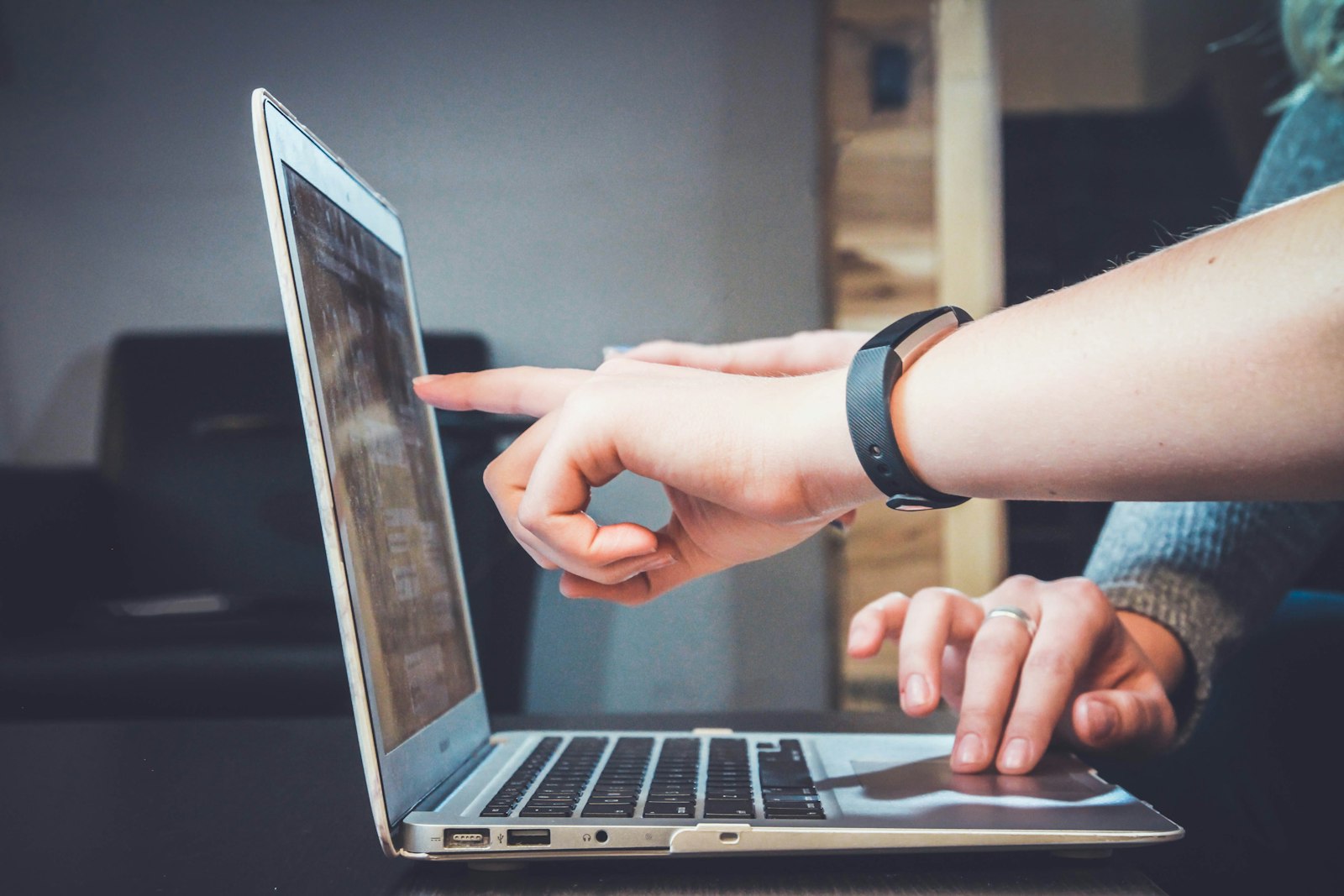 Hands typing on a laptop